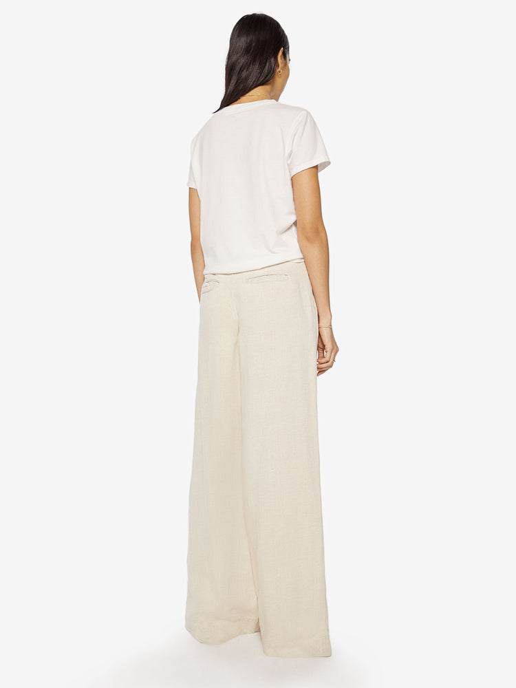 Back view of a woman Super high-waisted wide-leg pants with a long 34-inch inseam that puddles at the hem in a creamy hue.