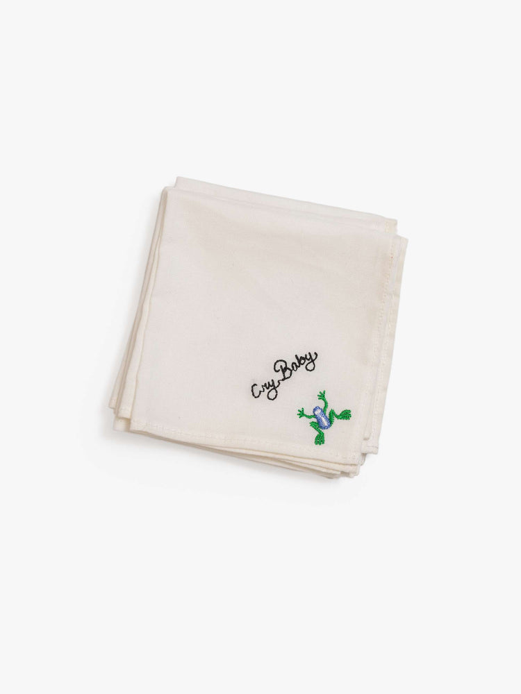 One of the set of five 8-inch-by-8-inch 100% cotton handkerchiefs in white with black embroidered text and colorful characters in the bottom corner.