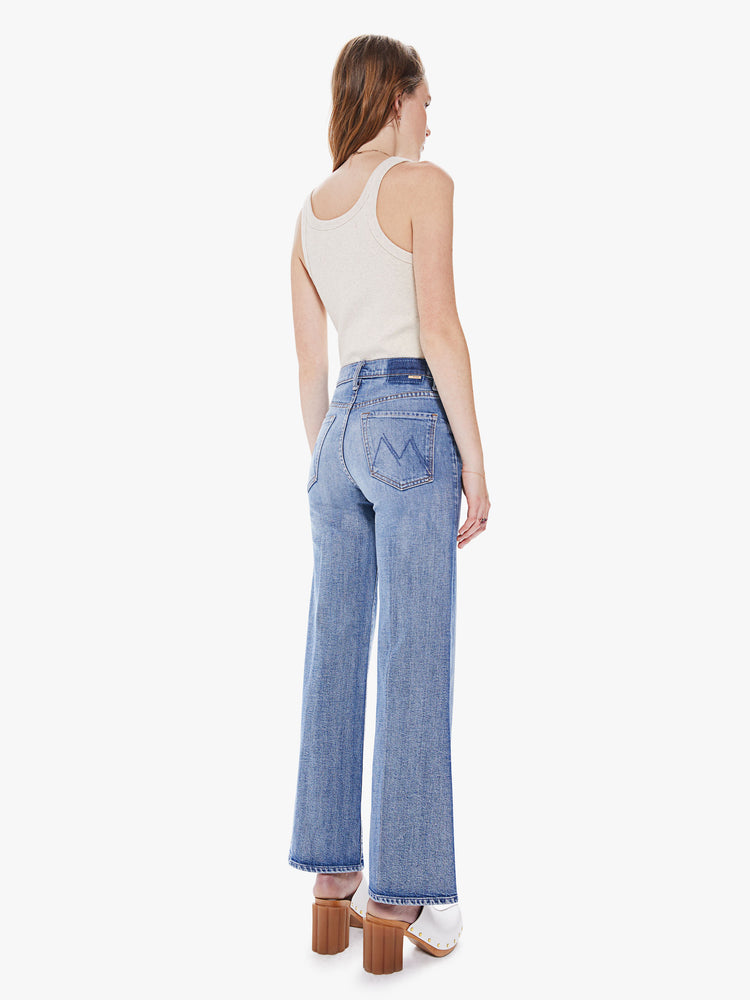 Back view of women's medium blue high waisted wide leg pant with exposed button fly