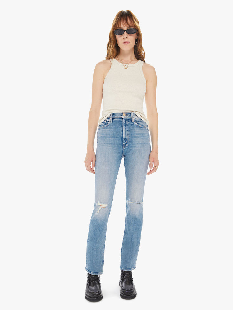 Front view of a women's light blue straight leg jean with a high rise and distressing at the knees