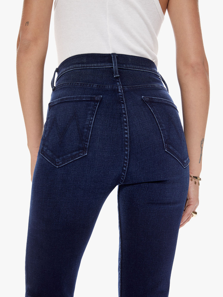 Back close up view of womens dark blue high waisted jean with straight leg and clean hem.