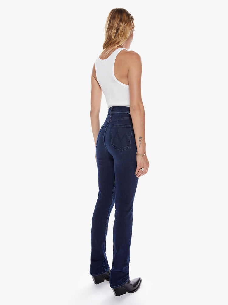 Back view of a womens high waisted dark blue wash jean with a straight leg and clean hem.