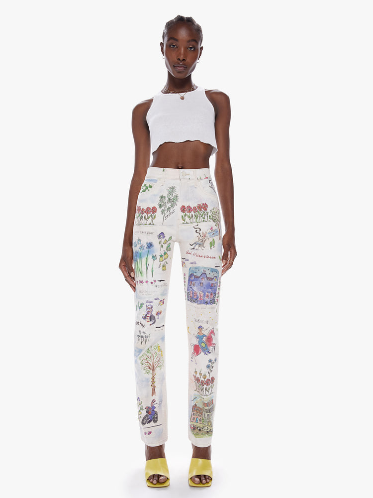 Front view of a woman high-waisted straight leg has a 31-inch inseam and a clean hem in an off-white hue with colorful, storybook-inspired graphic illustrations.