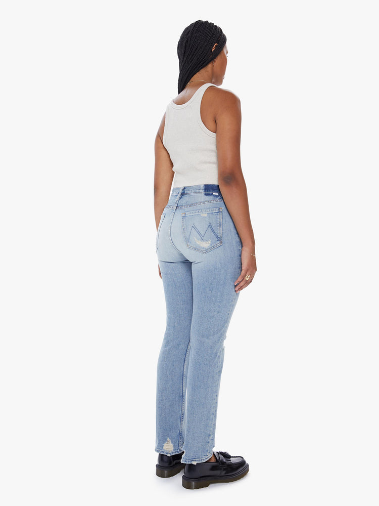 Back view of a womens high rise jean in a light blue wash, featuring a straight leg and distressed details throughout.
