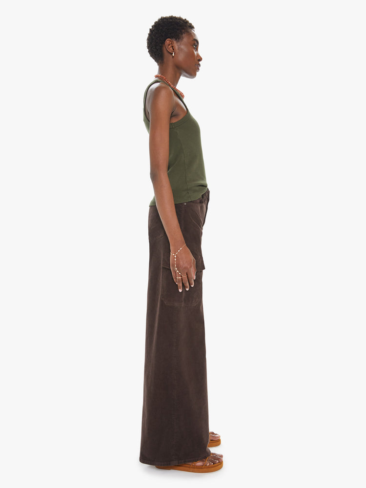 Side view of a womens brown corduroy pant featuring a high rise, wide leg, and cargo pockets.