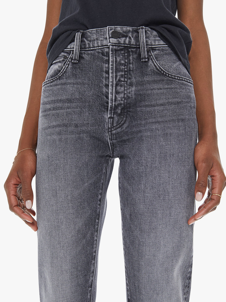 Front detail view of a women's faded black straight leg jean with a high rise and clean hem