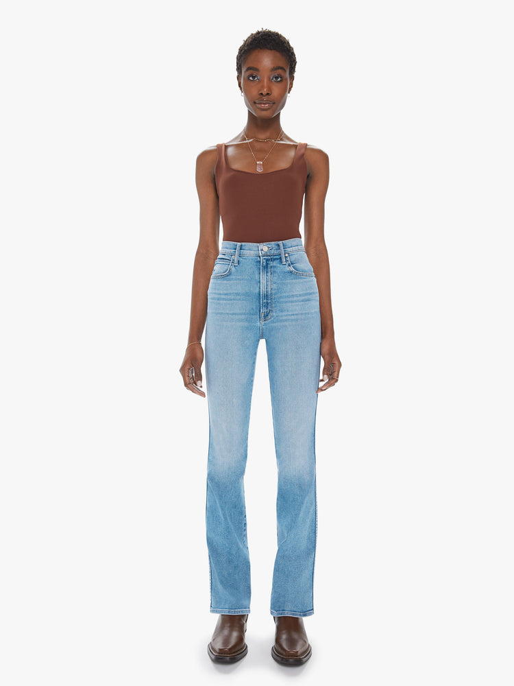 Front view of a womens light blue wash jean featuring a super high rise and a long flare leg.