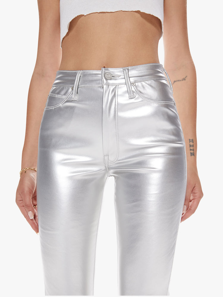 Close of view of a womens metallic silver faux patent leather high rise pant.