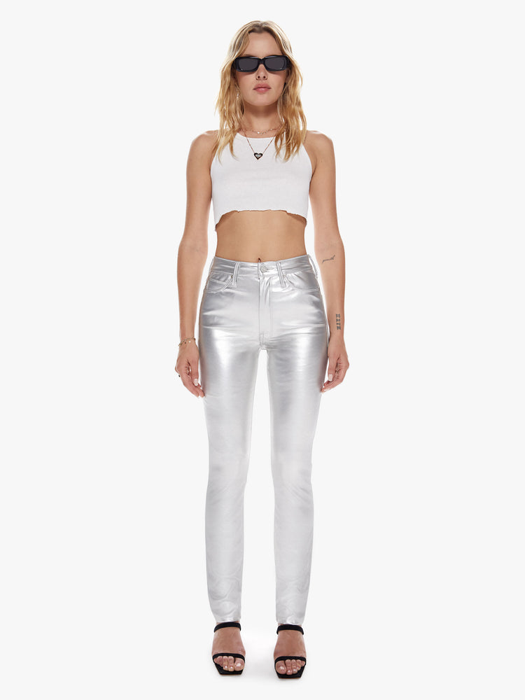Front view of a womens metallic silver faux patent leather high rise pant with a straight and clean hem.