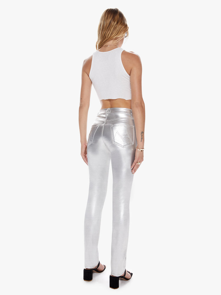 Back view of a womens metallic silver faux patent leather high rise pant with a straight and clean hem.