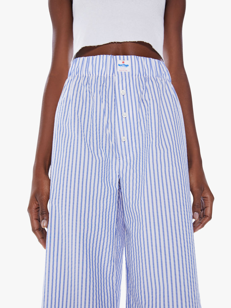 Close up view of a woman's wide-leg pants with a high elastic waist, boxer brief buttons and a long 31-inch inseam in a blue and white stripe pattern.
