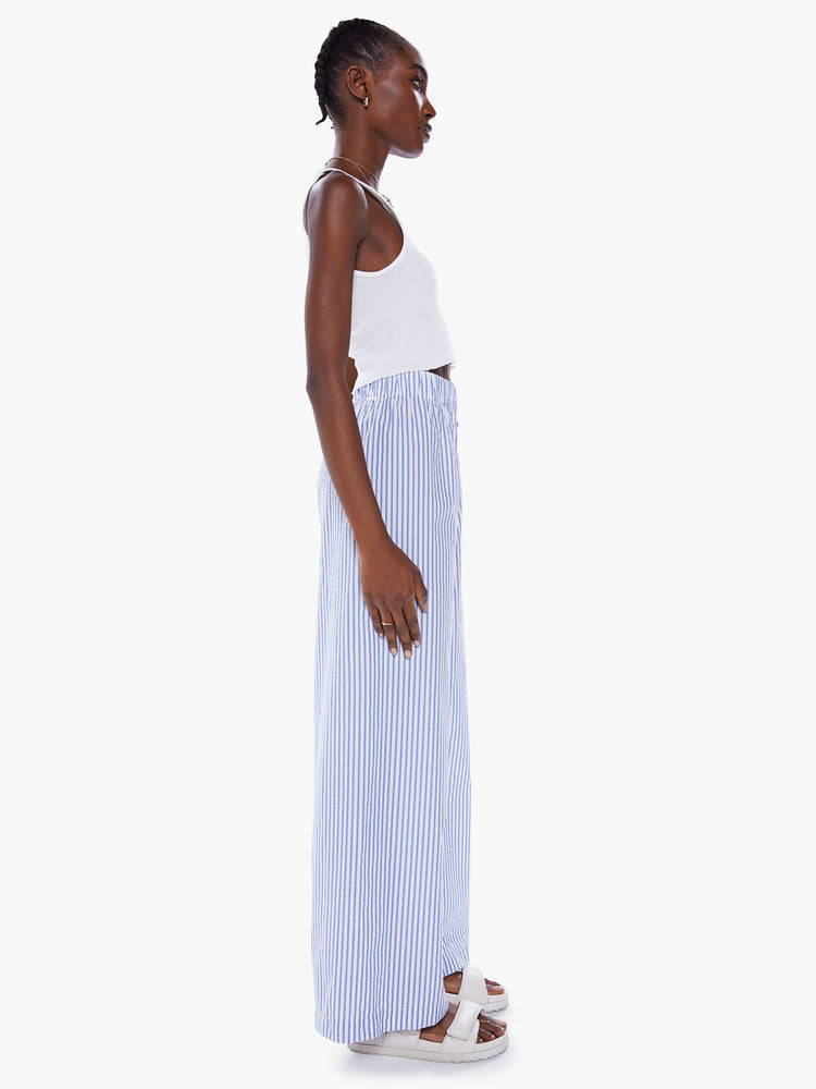 Side view of a woman's wide-leg pants with a high elastic waist, boxer brief buttons and a long 31-inch inseam in a blue and white stripe pattern.
