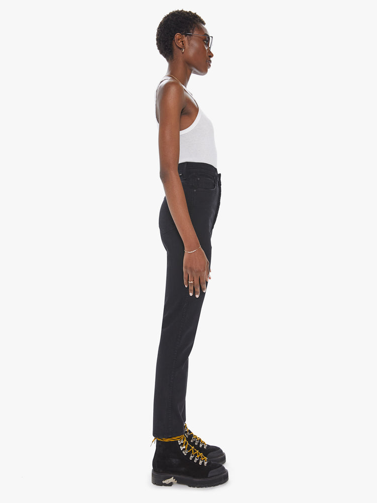 Side view of a womens black wash jean featuring a super high rise and a straight leg.