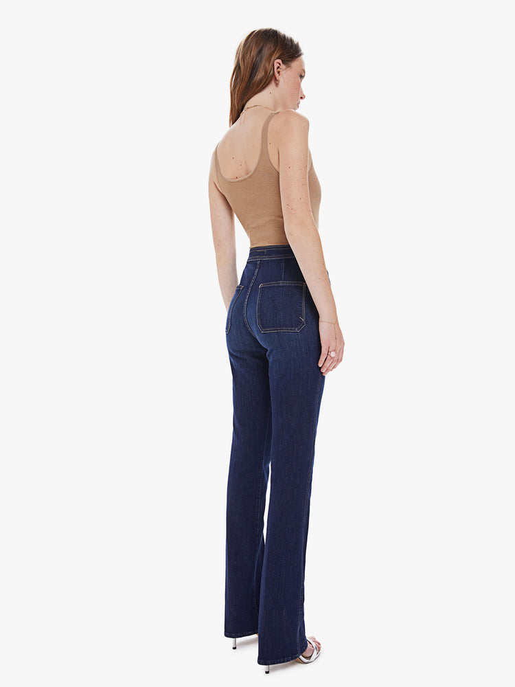 Back view of a women's dark blue high rise straight leg jean with a long clean hem
