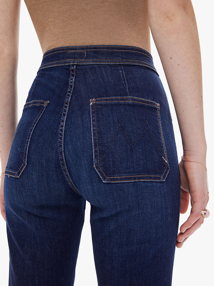 Back detail view of a women's dark blue high rise straight leg jean with a long clean hem
