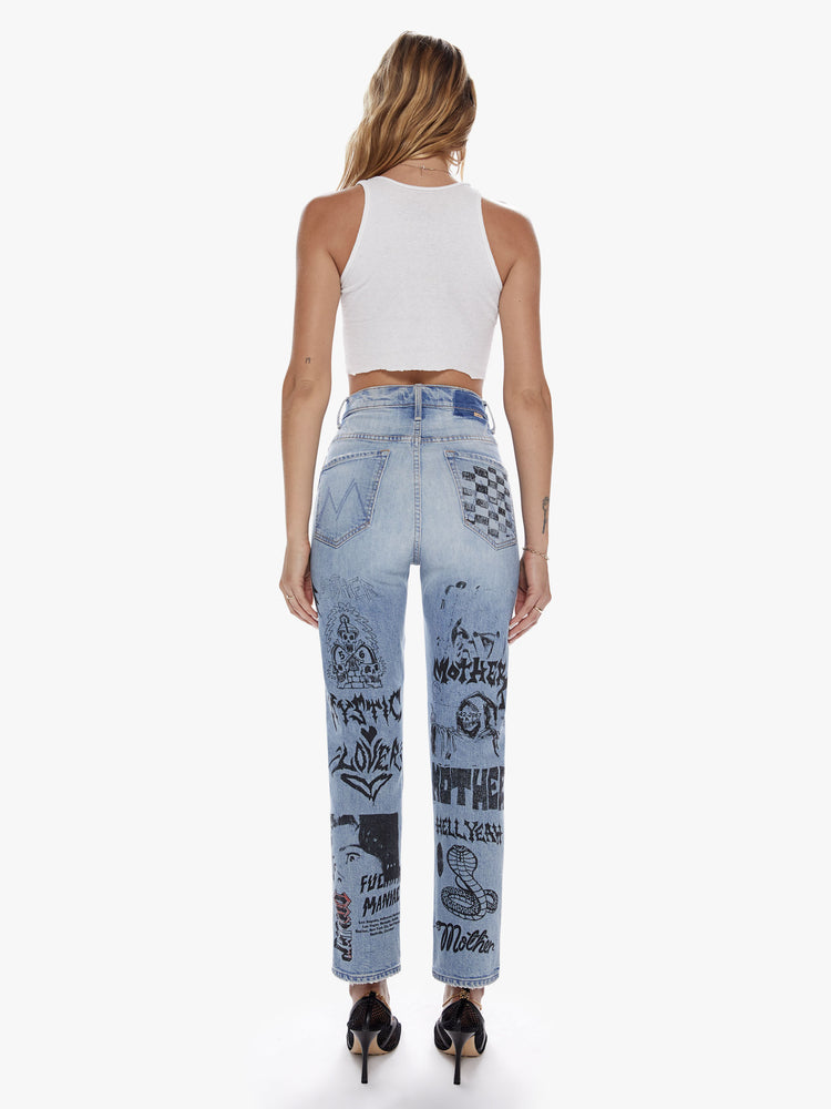 Back view of a woman in an ultra high waisted straight leg with a button fly and a clean ankle length inseam cut from semi rigid superior denim in a light blue wash with whiskering, fading and angsty graphic doodles down the legs