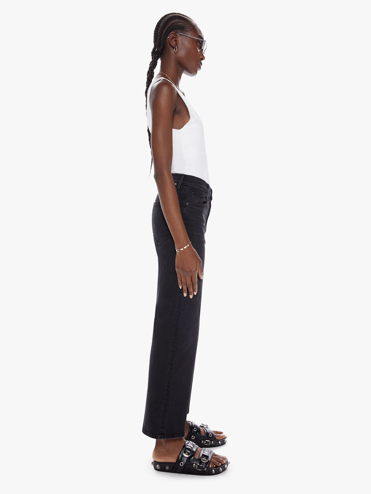 Side view of a womens black high waisted wide straight leg jean with an ankle length inseam and zip fly.