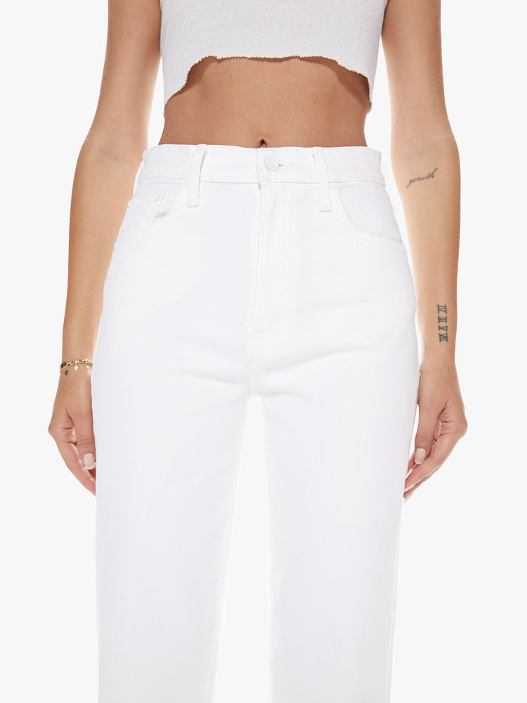Close up waist view of a womens white high waisted wide straight leg jean with an ankle length inseam and zip fly.