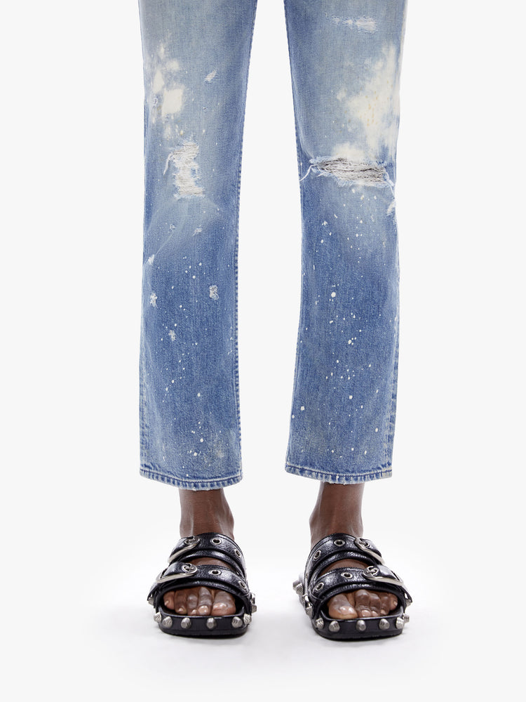 Close up hem view of a woman in a perfect high waisted leg jean with ankle length inseam and a clean hem, cut from semi-rigid superior denim in the shade LOL which is a limited edition mid-blue wash with fading,whiskering, paint splatters and bleaching all done by hand