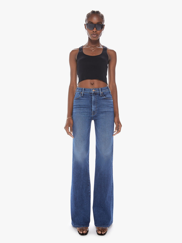 Front view of a womens wide leg dark blue wash jean with a high rise, clean hem and fading at the knees.