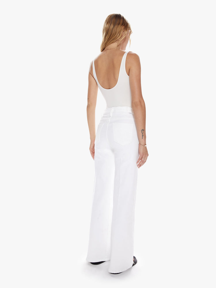 Back Full body view of a woman in a white 70's inspired wide leg with high rise, 31 inch seam and clean hem
