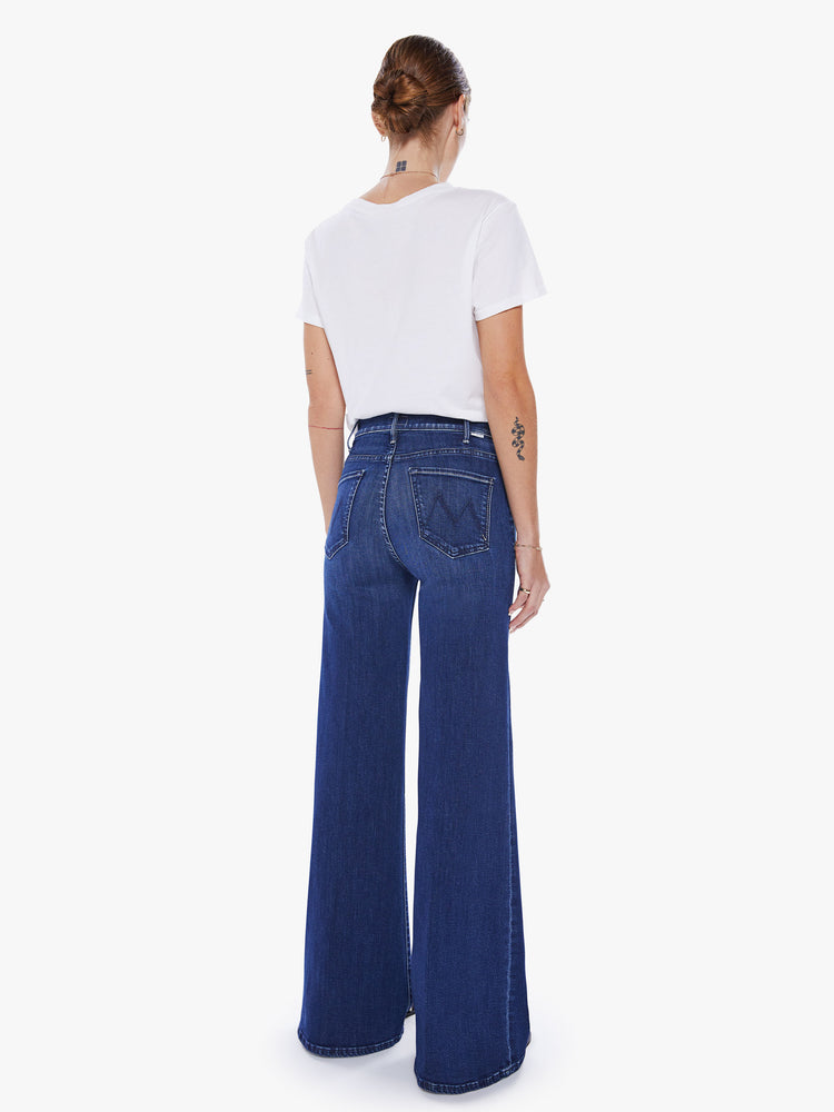 Back view of a woman wide leg jeans with a high rise, 32-inch inseam and a clean hem in a dark blue wash.