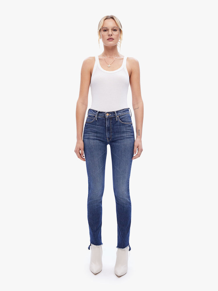 Front view of a womens dark blue wash jean featuring a mid rise, straight leg, and a step crop fray.
