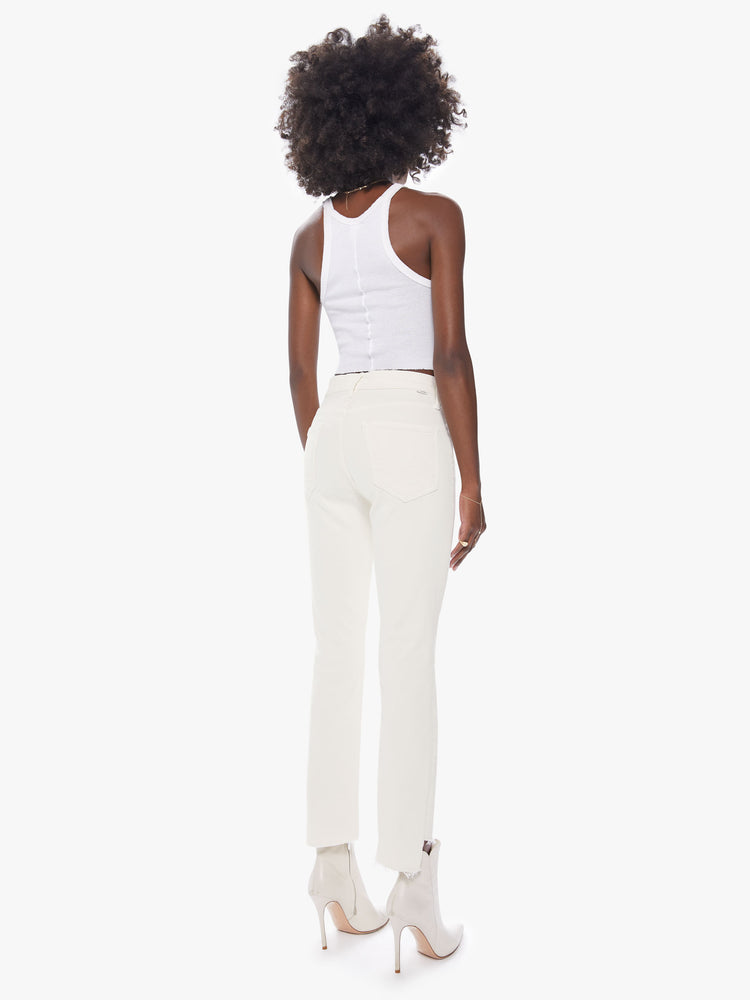 Back view of a women's mid rise straight leg pant with an ankle length step frayed hem
