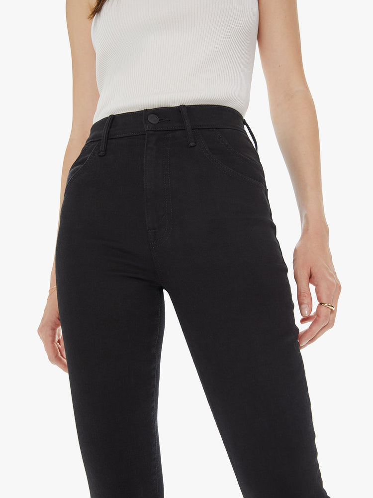 Front detail view of a women's black high waisted skinny jean with double pocket details