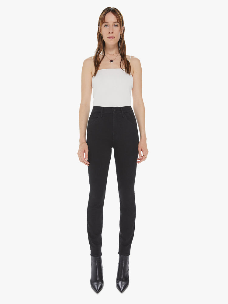 Front view of a women's black high waisted skinny jean with double pocket details