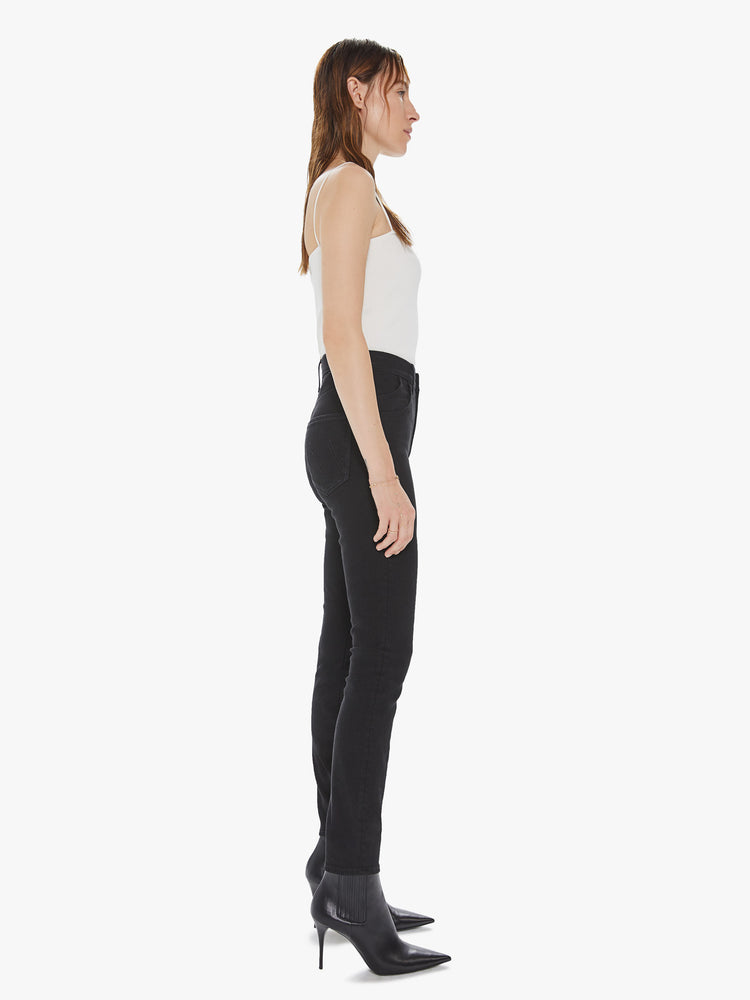 Side view of a women's black high waisted skinny jean with double pocket details