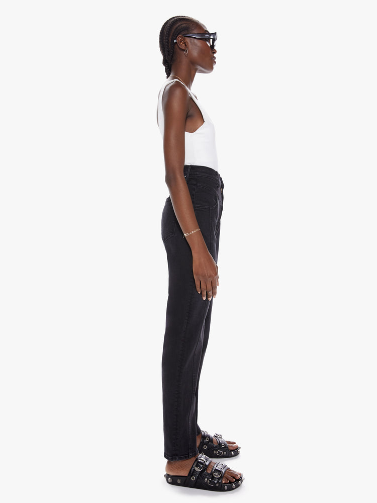 Side view of a black super high waisted jean with a straight leg and v-shaped seam at the waist, thighs and straight down the front.