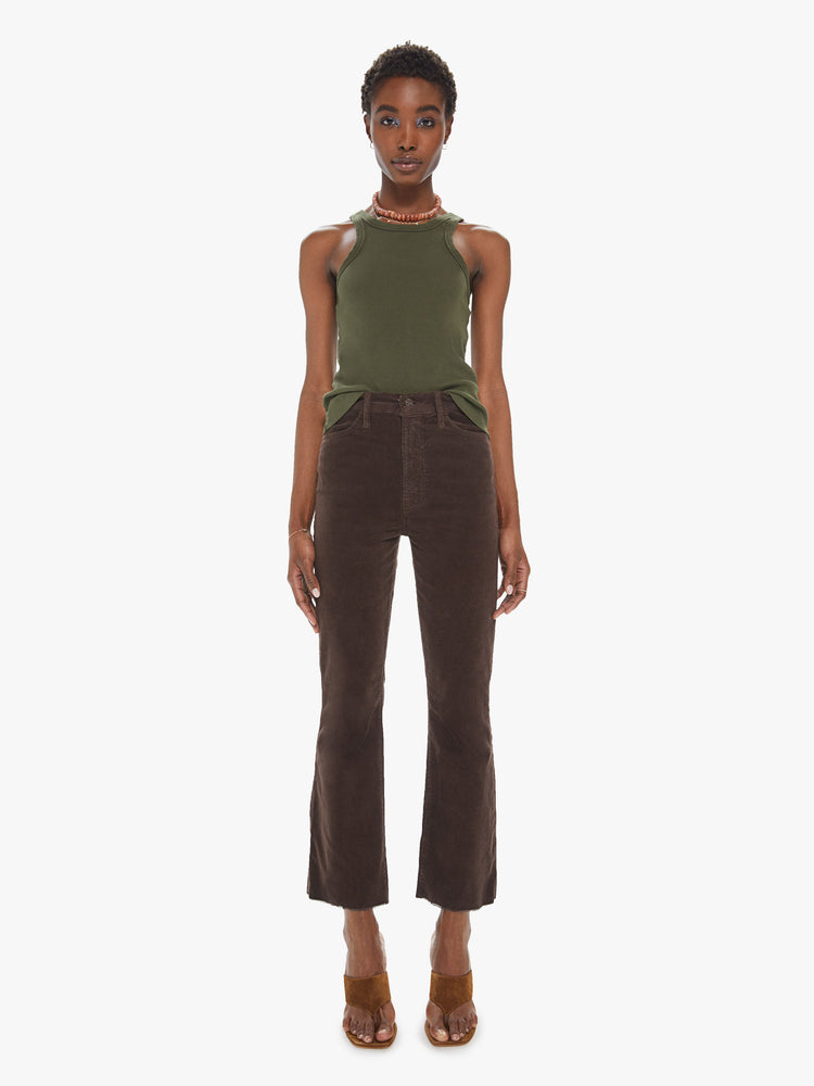 Front view of a womens brown corduroy pant featuring a high rise and a raw cut flare hem.