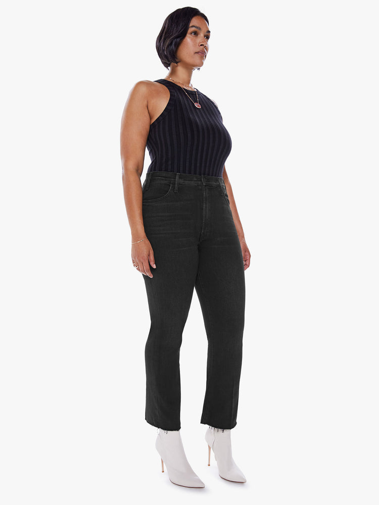 Front side view of a womens black wash jean featuring a high rise, flare leg, and frayed hem.
