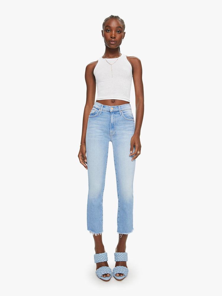 Front view of a womens light blue jean featuring a high rise, bootcut, and a crop step frayed hem.
