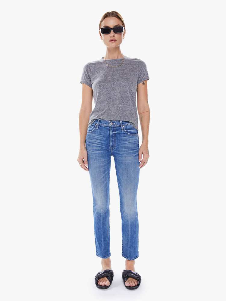 Front view of a woman's mid-rise straight leg with an ankle-length inseam and a clean hem in a mid blue wash.