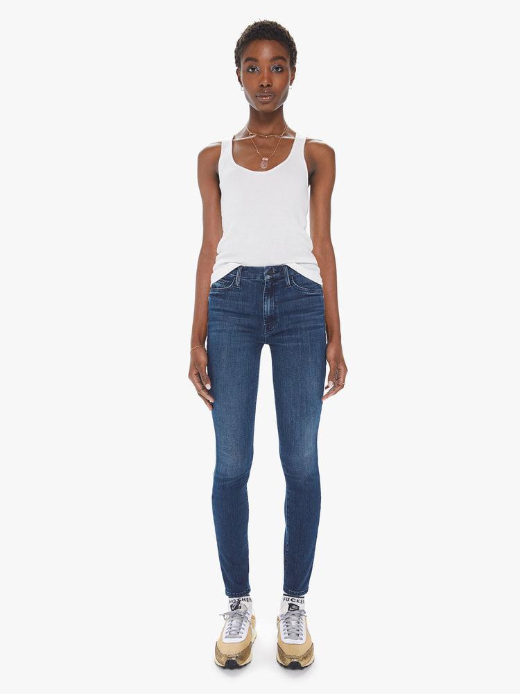 Front view of a womens dark blue wash jean featuring  high rise, skinny leg, and a clean hem.
