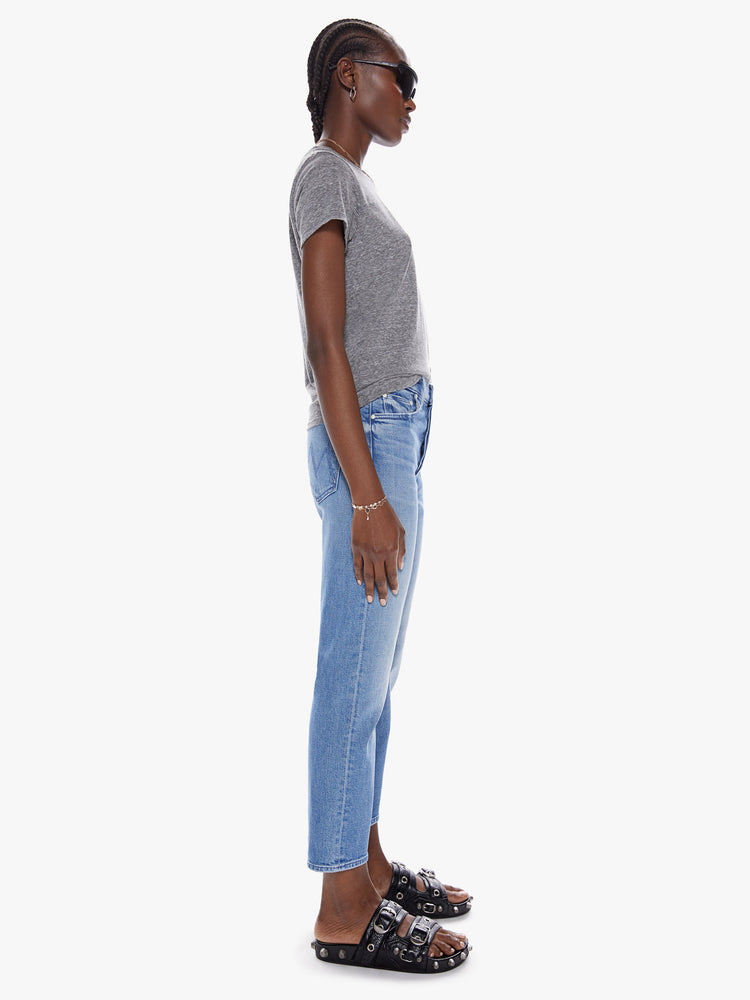 Side view of womens high rise medium blue wash jean with straight leg, ankle length inseam, button fly and fading at the knees.