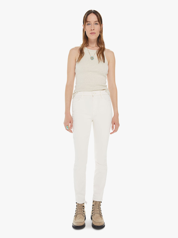 Front view of a womens off white pant featuring a high rise, skinny fit, and a clean ankle length hem.