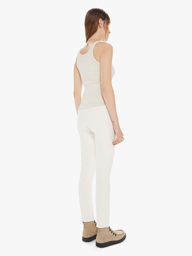Back view of a womens off white pant featuring a high rise, skinny fit, and a clean ankle length hem.