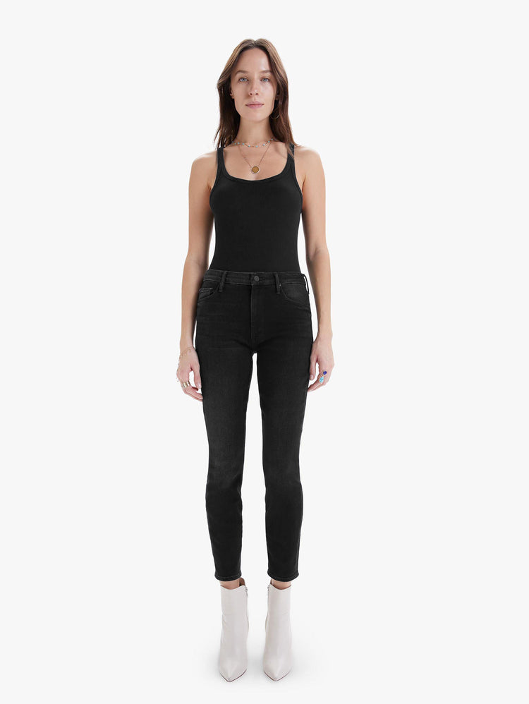 Front view of women's black high rise skinny jean with clean hem.