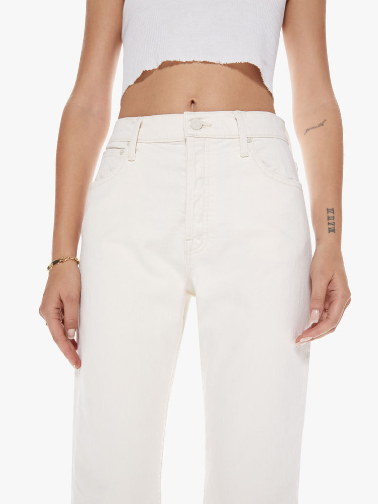 Front close up view of a womens off white cropped pant with a button fly.
