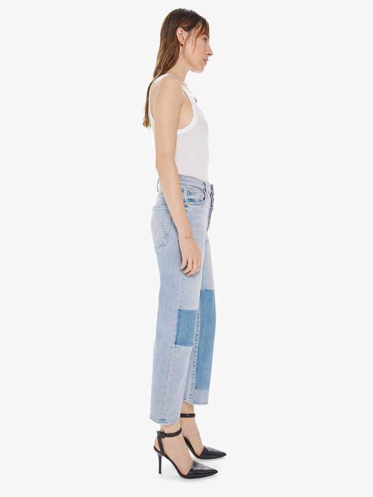 Side view of a women's light blue straight leg jean with a high rise and a shadow effect on the front legs