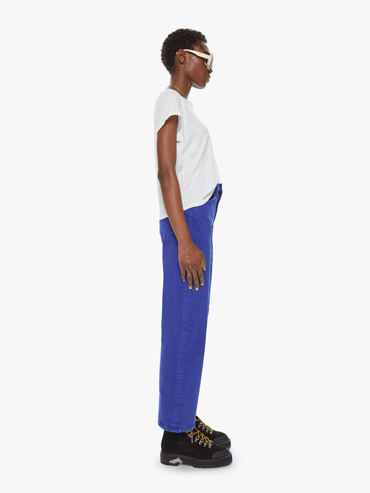 Side view of a womens bright blue jean featuring a high rise and ankle length straight leg.