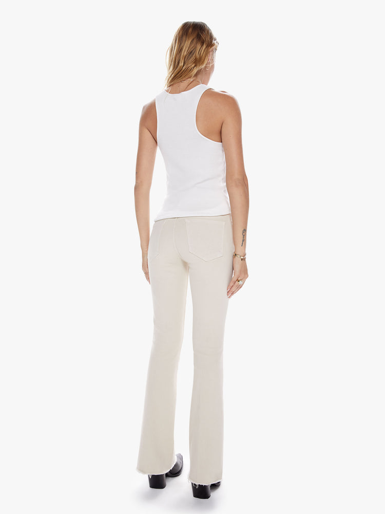 Back view of womens cream-grey mid rise jean with a flare leg and frayed hem