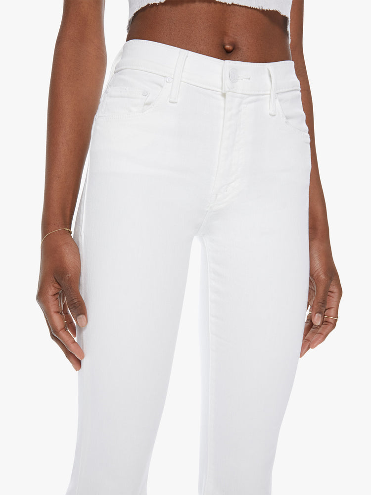 Front close up view of a white wash jean featuring a mid rise.