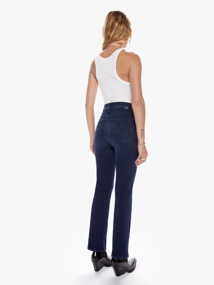 Back view of a womens dark blue wash jean with a ultra high rise, button fly and clean ankle length hem.