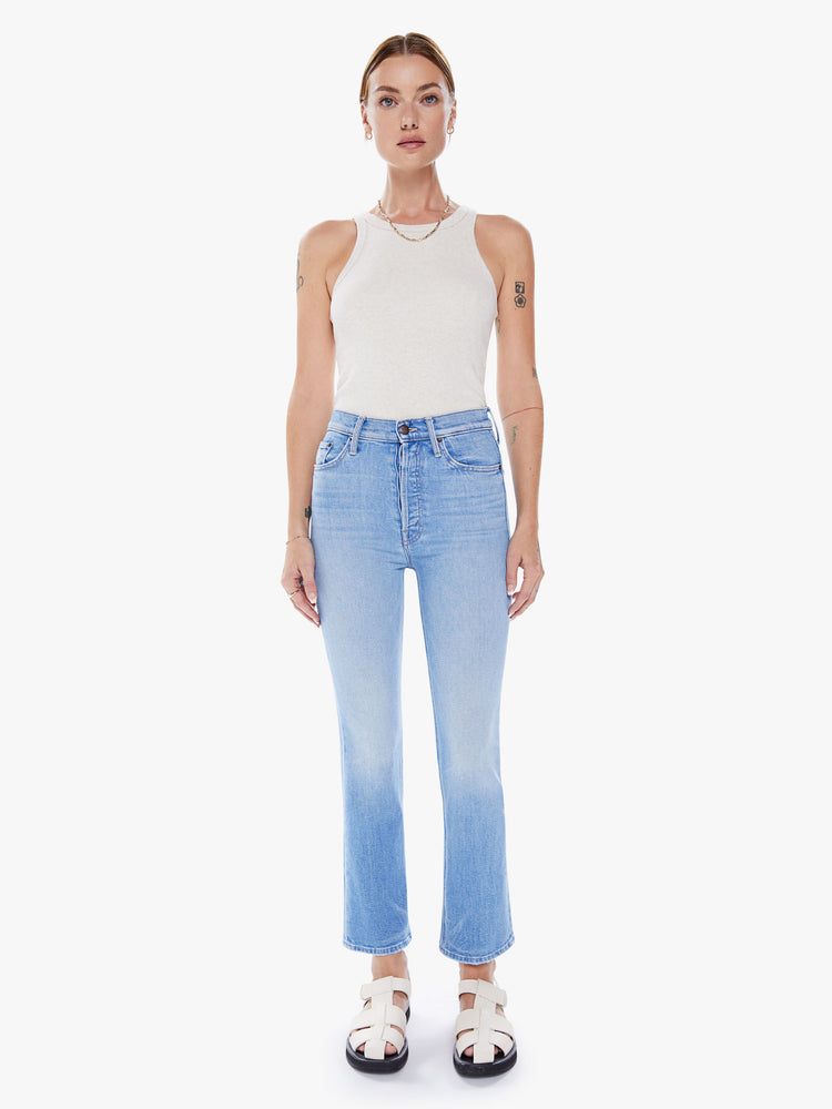 Front view of a woman ultra high-rise flare jean with a button fly and a clean ankle-length hem in a light blue wash.