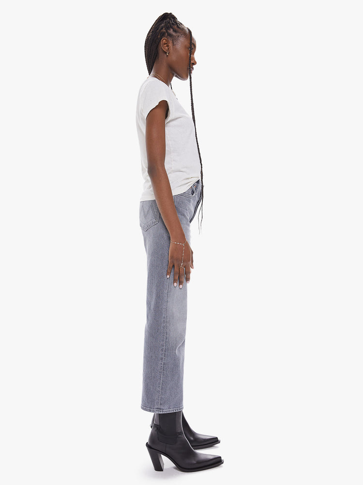 Side view of a women's light grey high rise straight leg jean with a clean ankle length hem