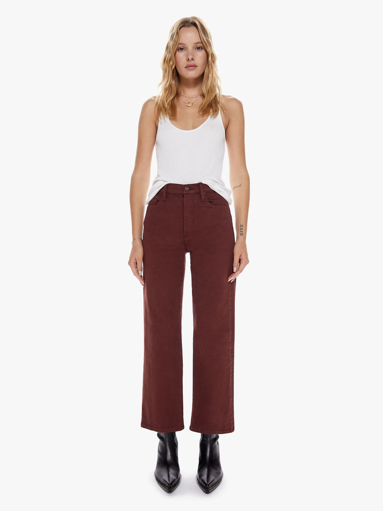 Front view of a womens brown burgundy high waisted wide straight leg pant with an ankle length inseam and button fly.